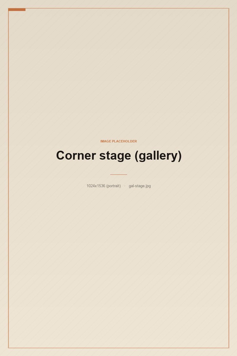 The corner stage with a single acoustic guitar leaning on a stool