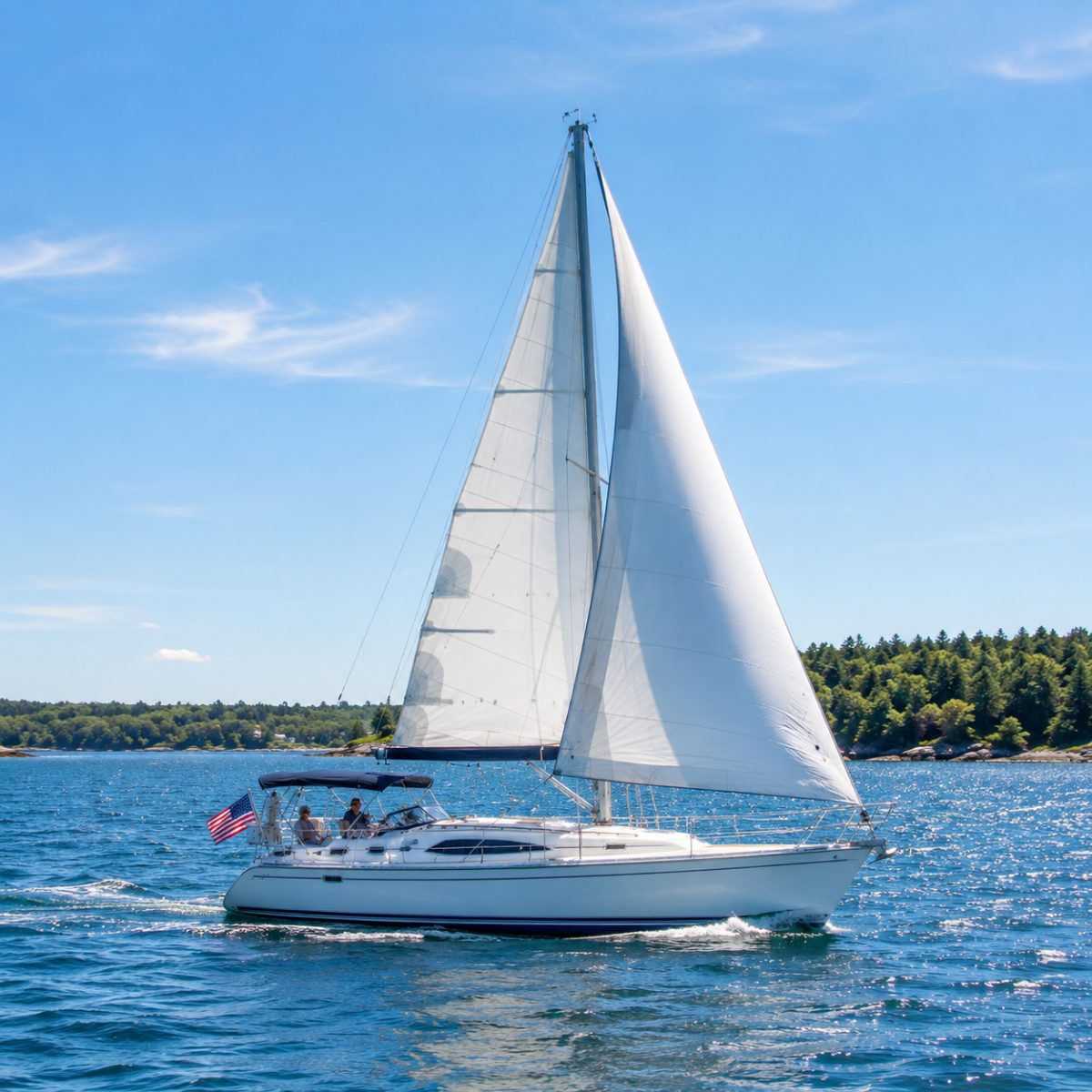 34-foot sailing sloop under full white sail on bright blue water