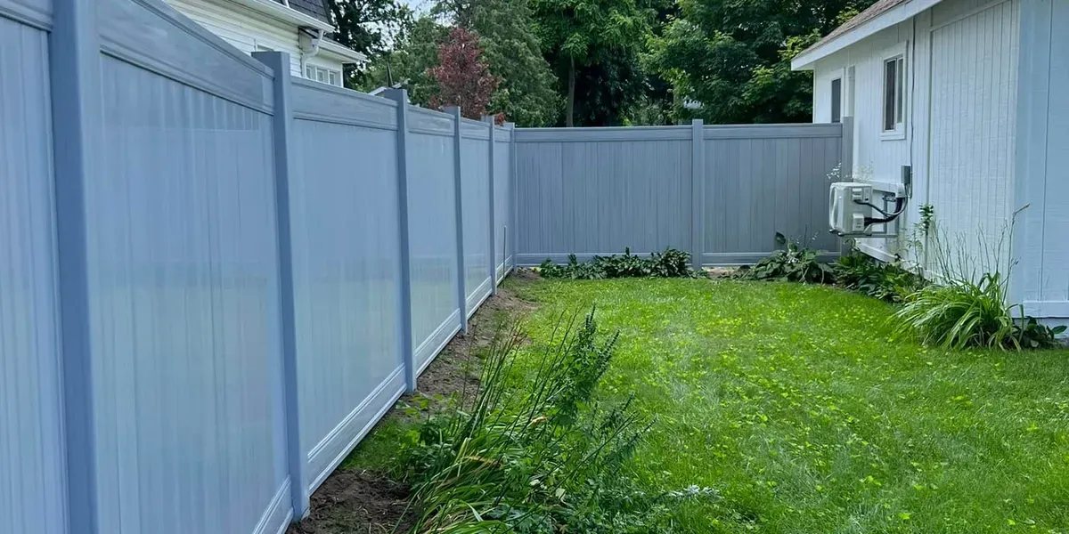Vinyl privacy fence along a green backyard